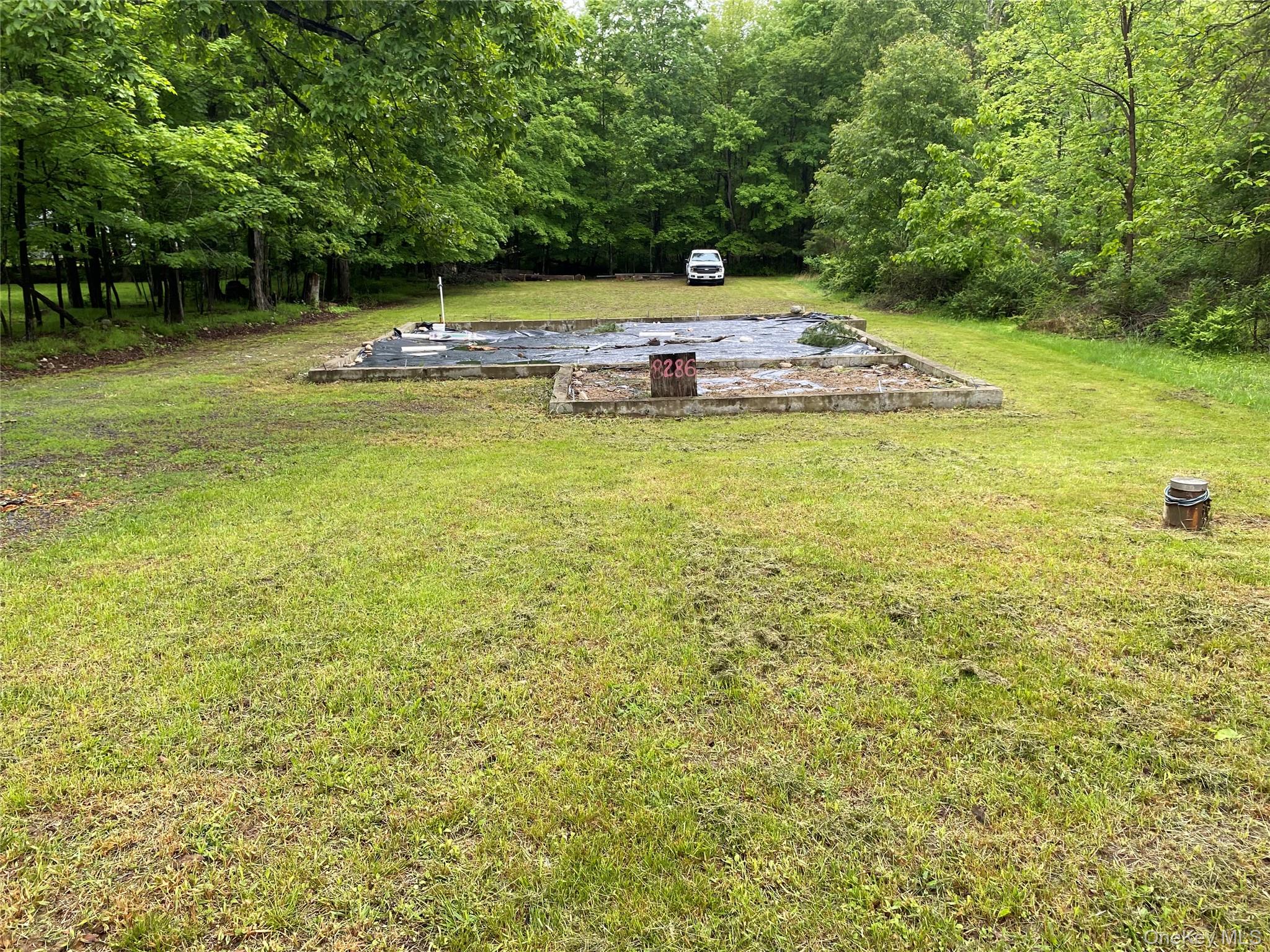 View of green lawn with a view of trees