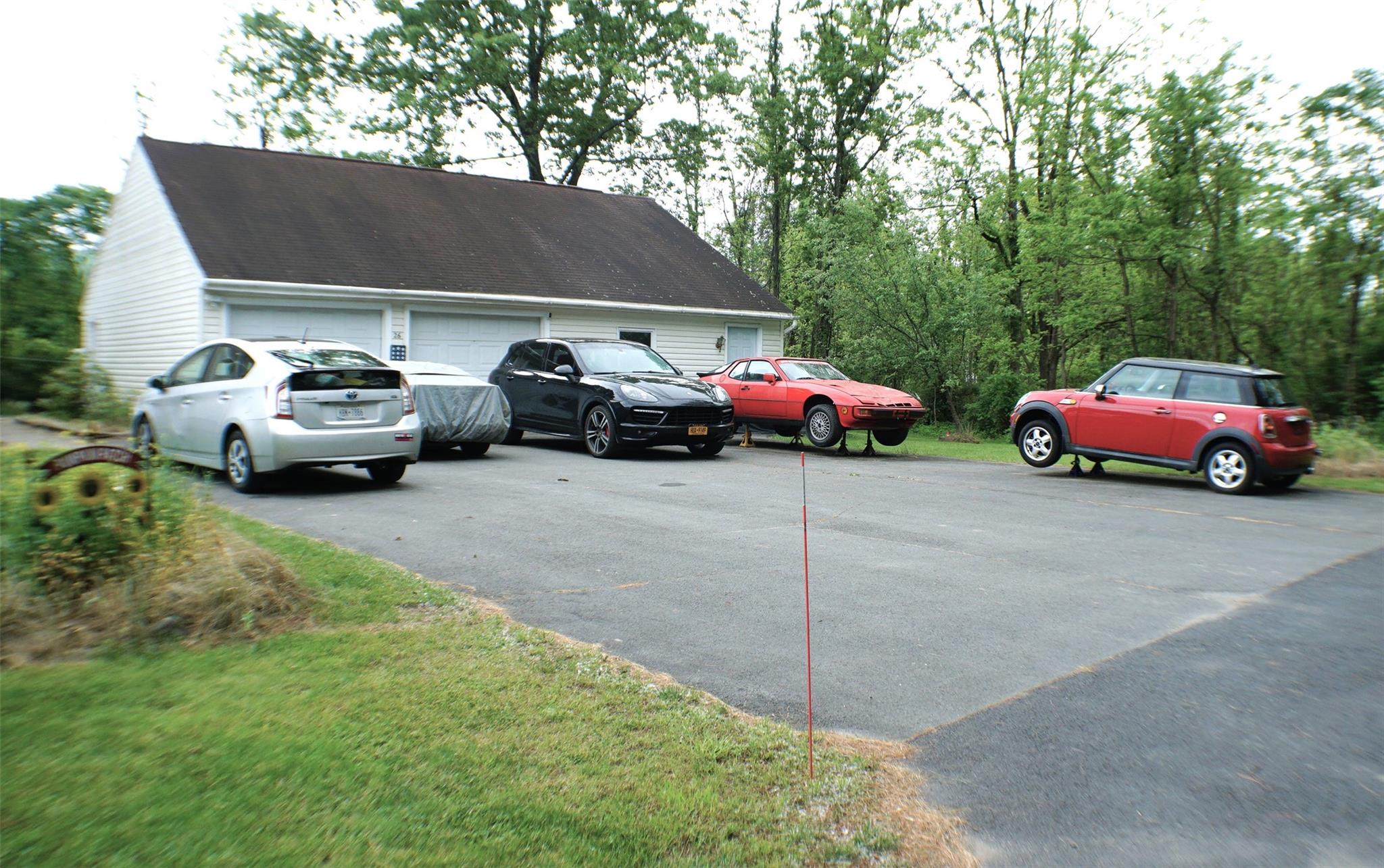 View of parking / parking lot with a garage