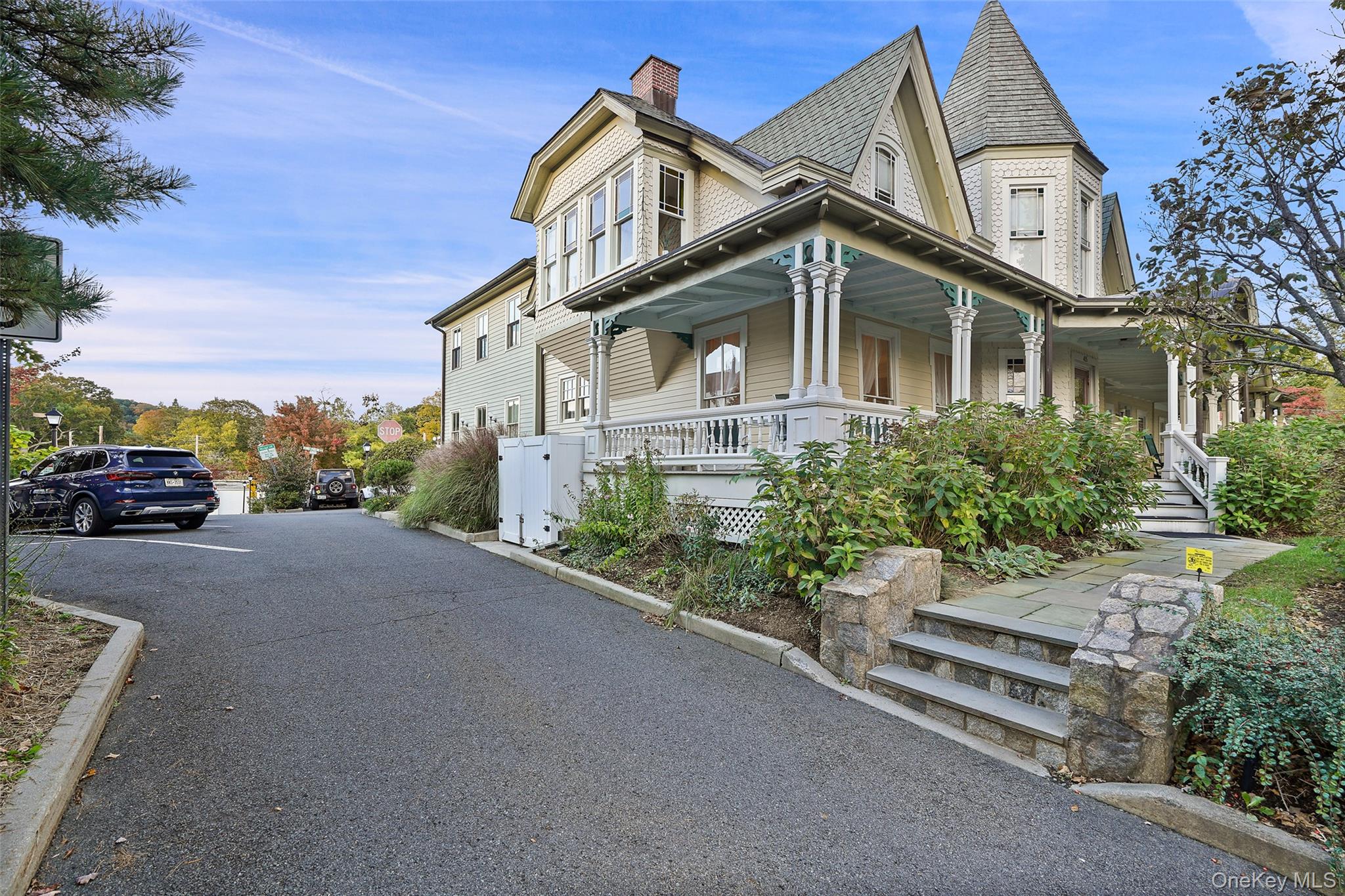 Victorian-style house featuring a porch and a chimney