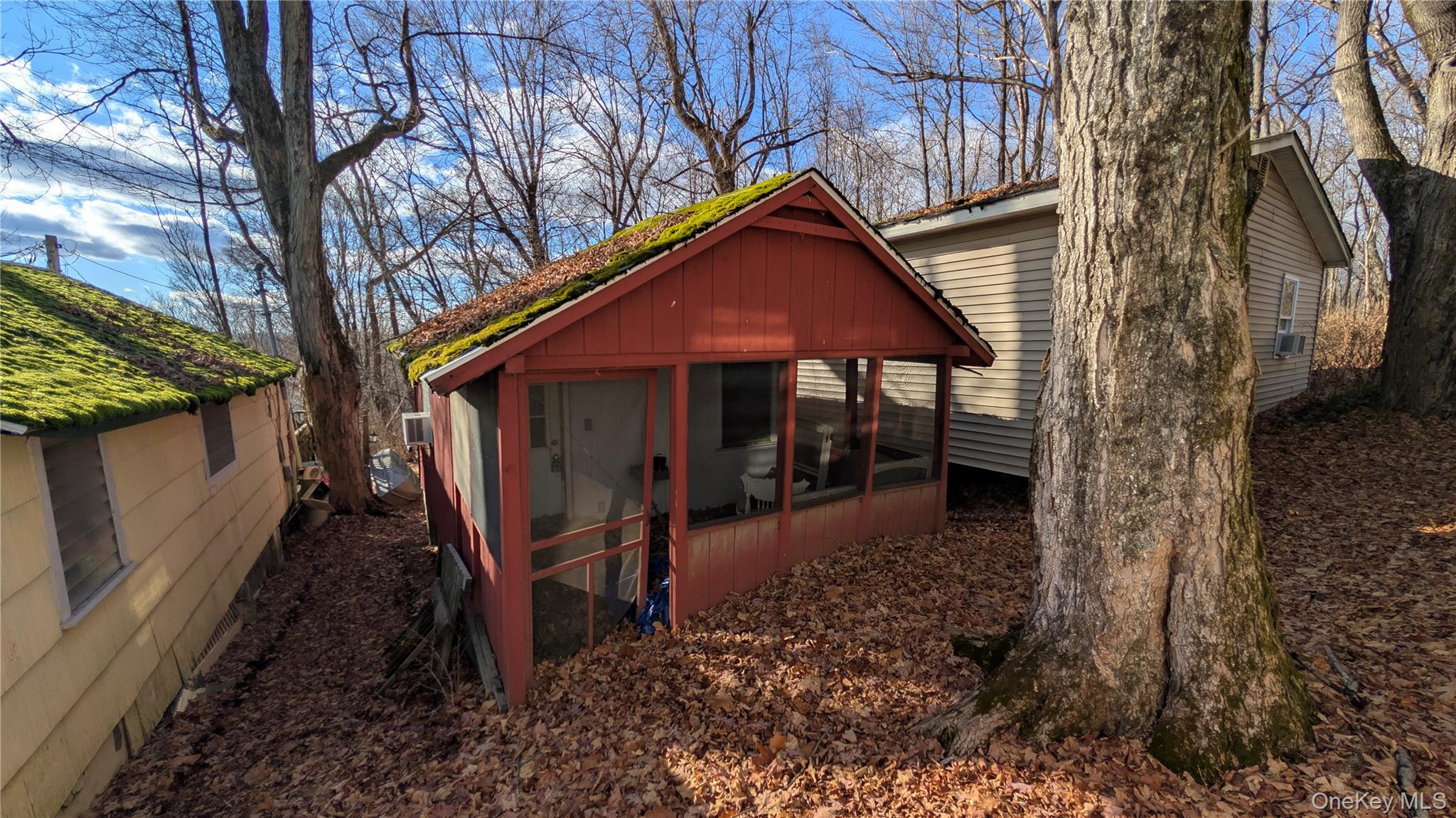 View of outdoor structure with a sunroom and cooling unit