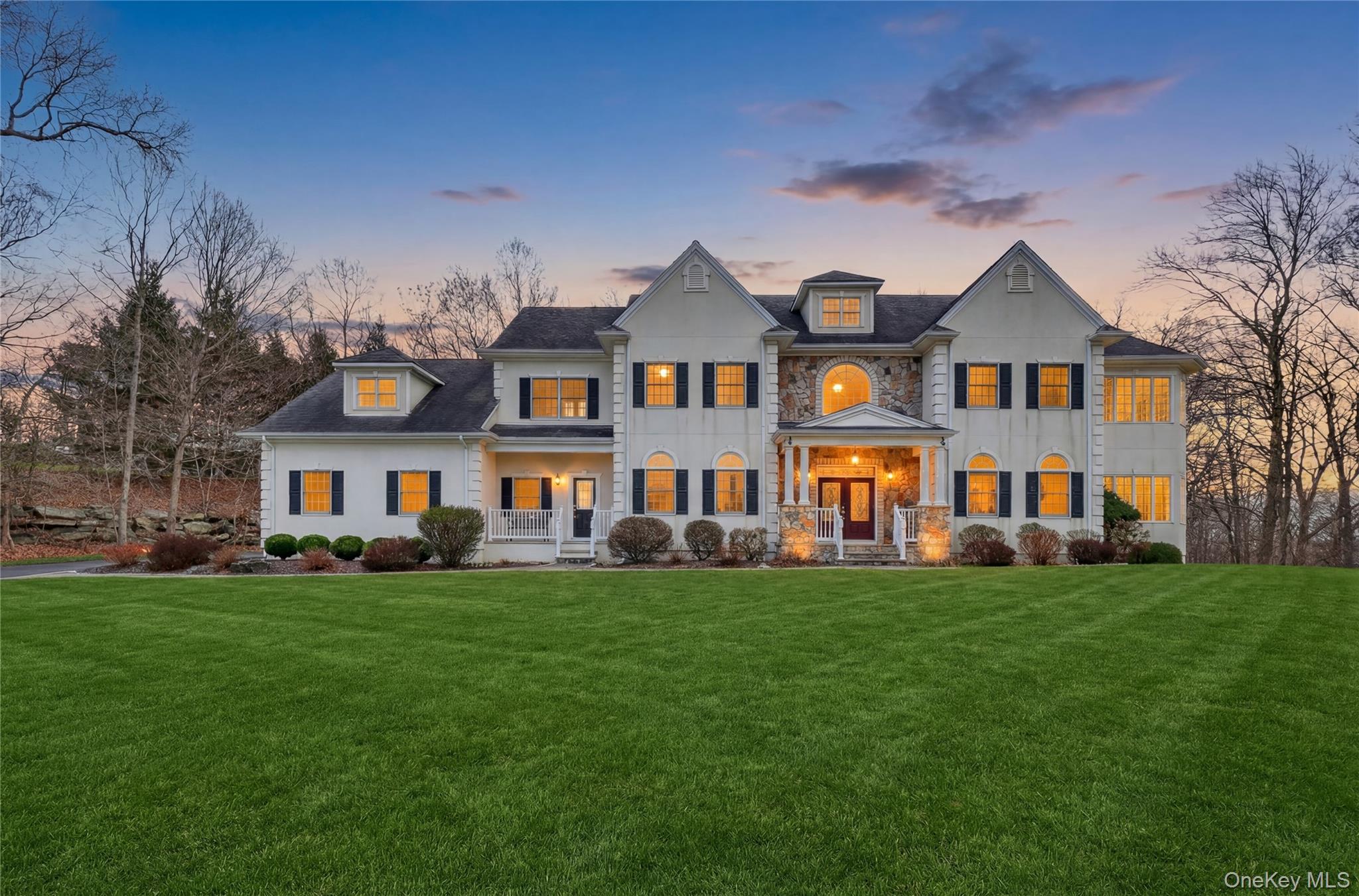 Twilight view of a premier home in Willow Ridge offering 10 ft ceilings on the main level with a wonderful conservatory, 9 ft. ceilings on the upper level.