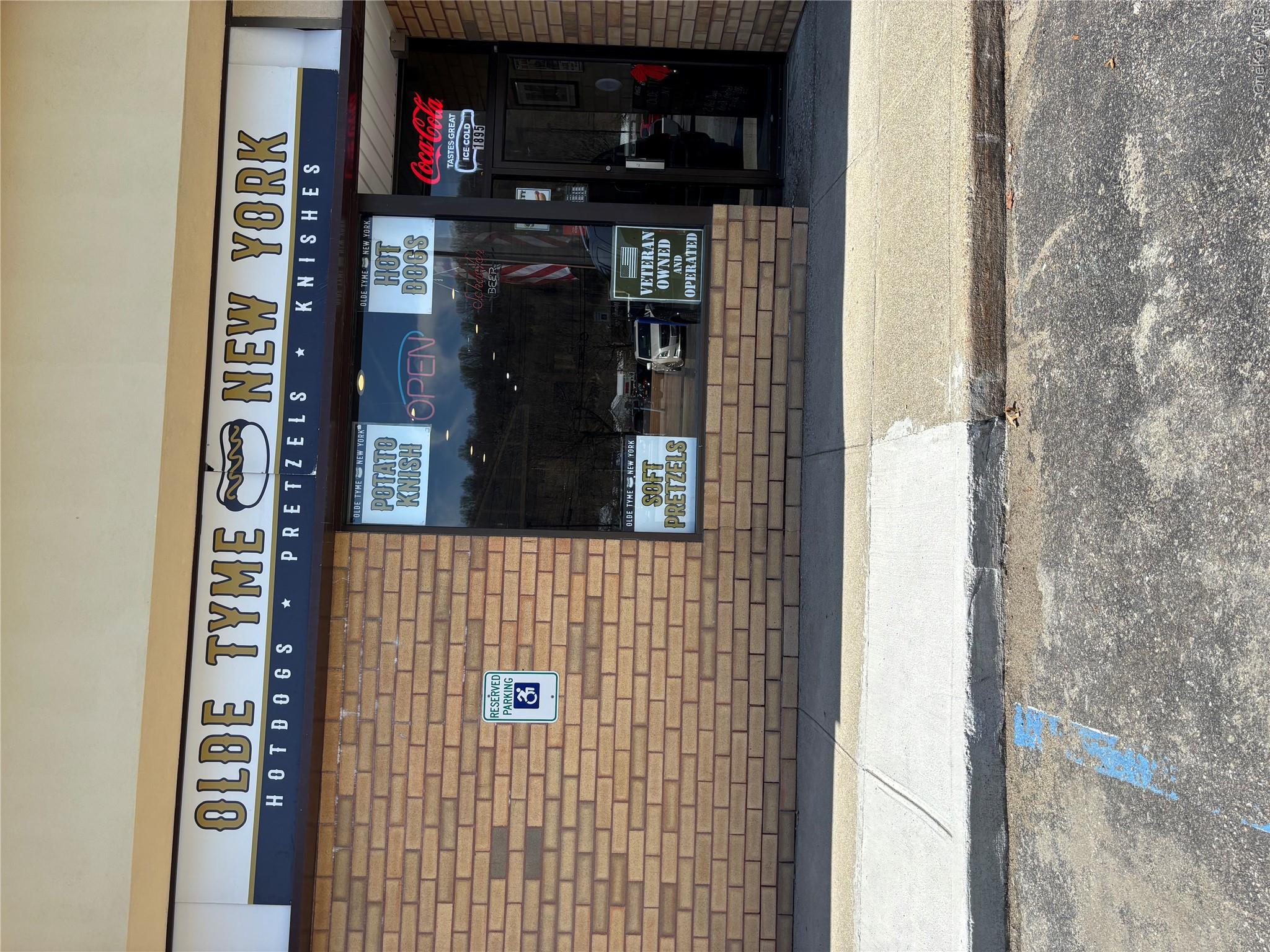 Commercial storefront featuring a brick facade and prominent signage