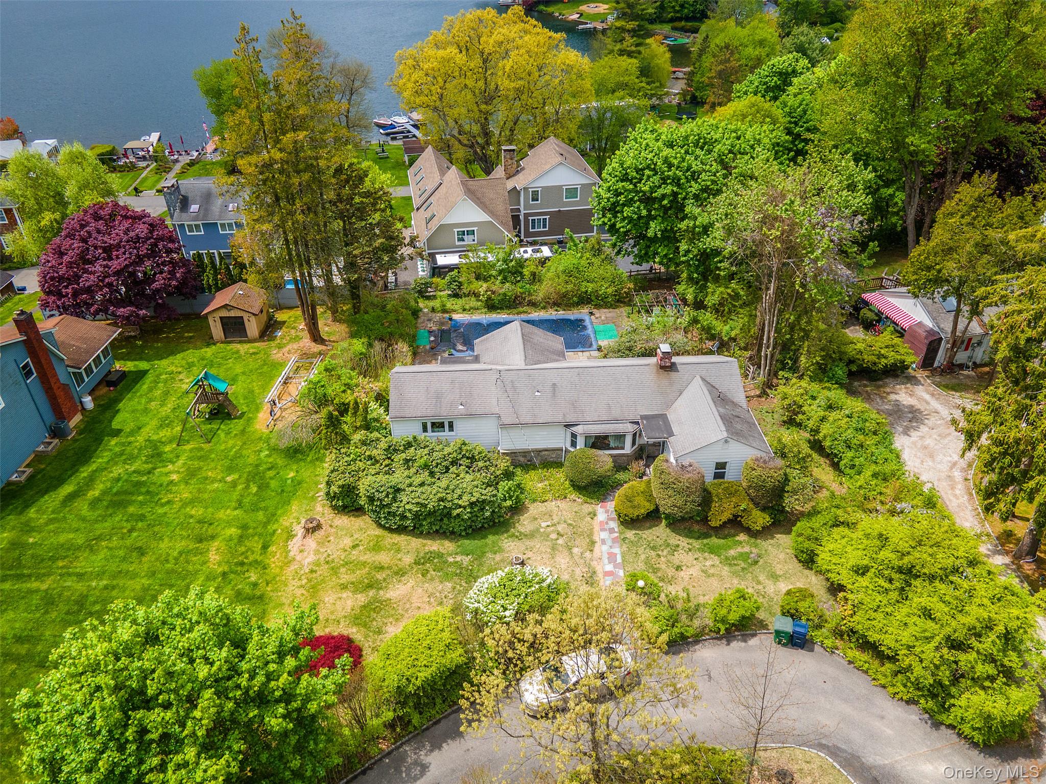 Ranch home with circular driveway, pool and deeded lake rights