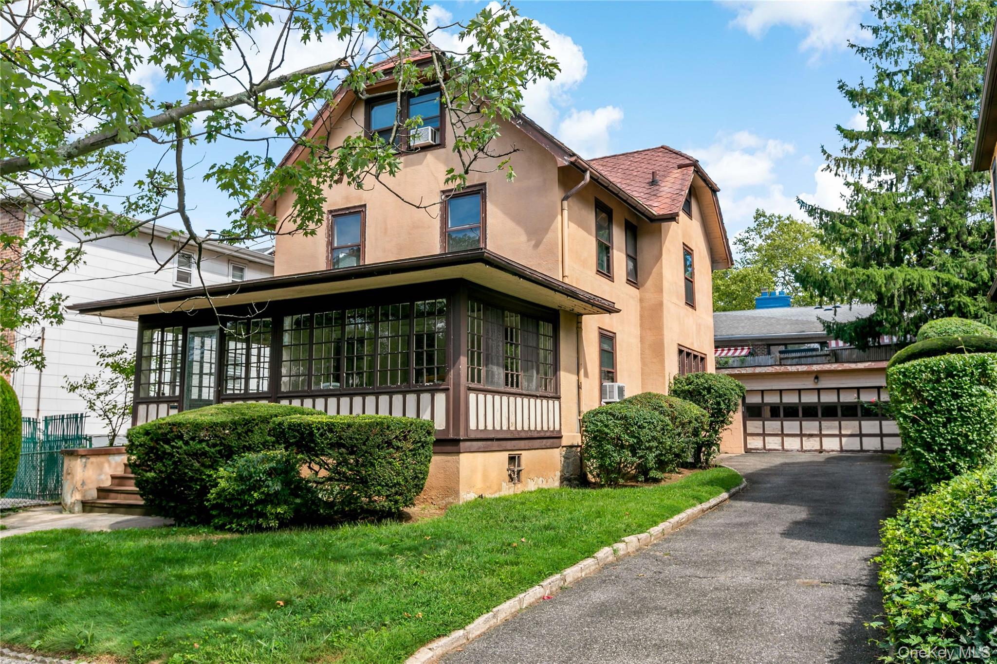Welcome to 33 Melrose Avenue-front exterior of home with view of long driveway and detached garage.