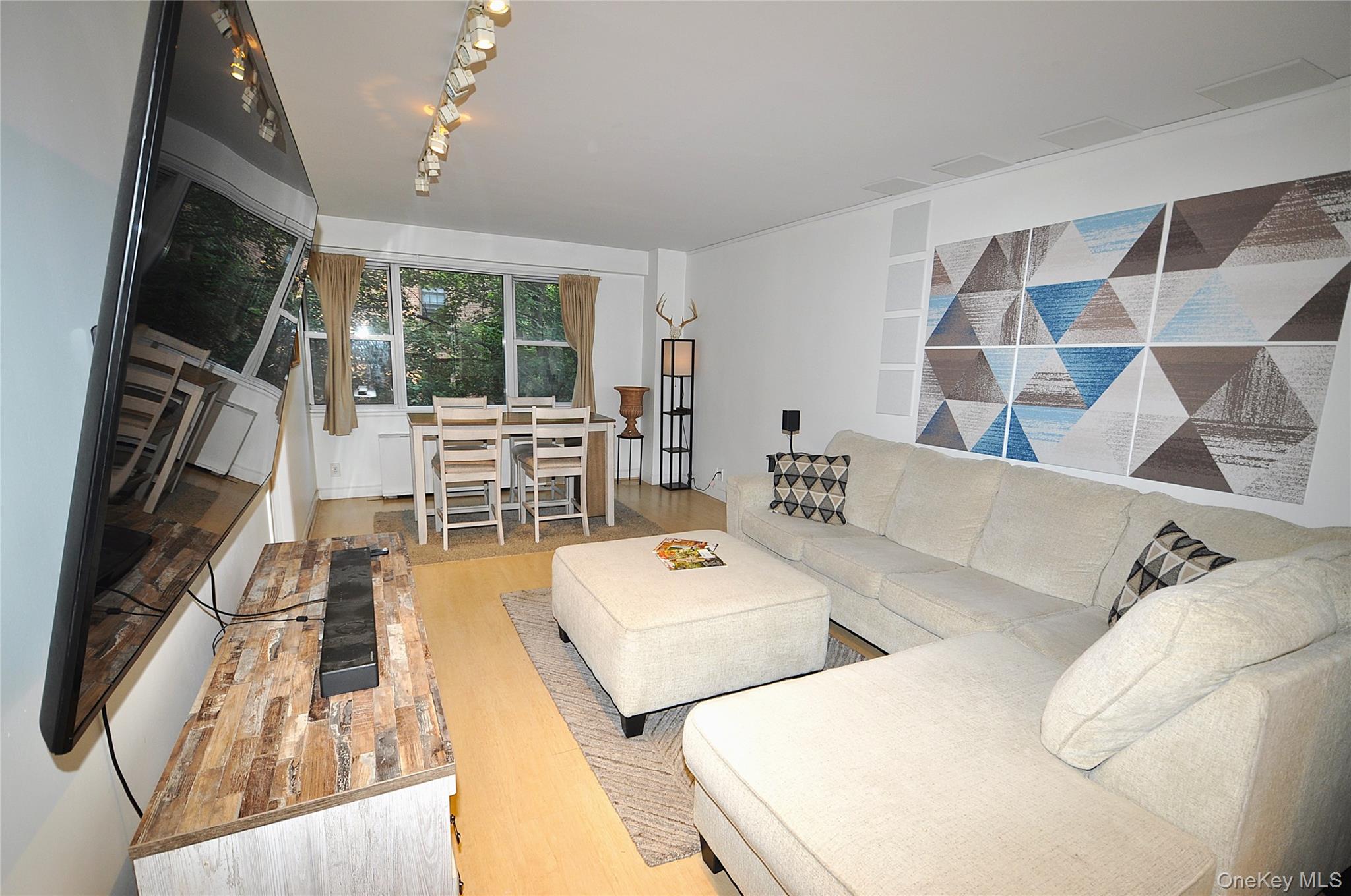 Large living room can accommodate both a entertainment and dining area.  The living room is approx. 31'-8\" x 11'-9\".
