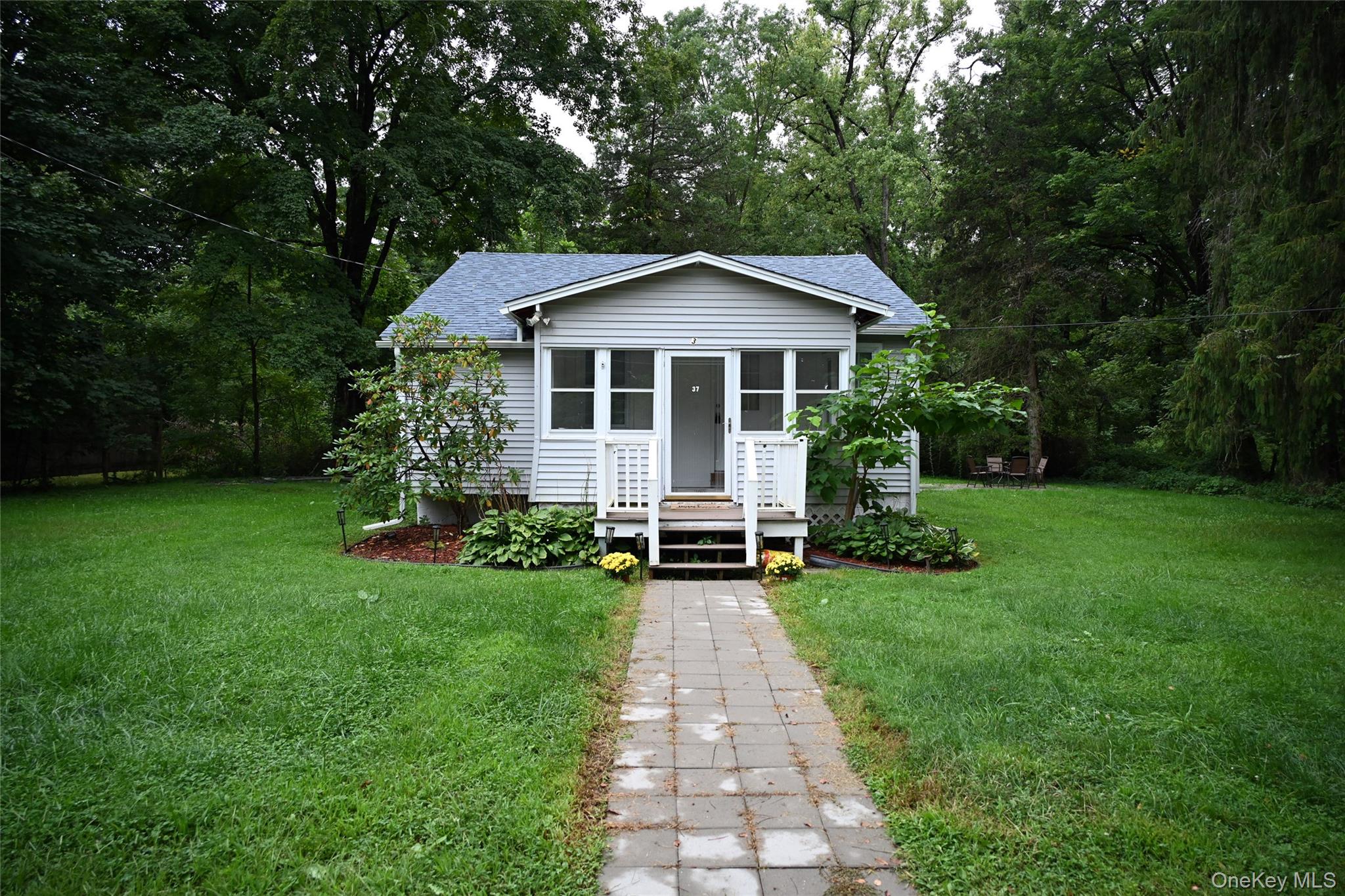 Light-colored siding exterior with a dark-shingle roof