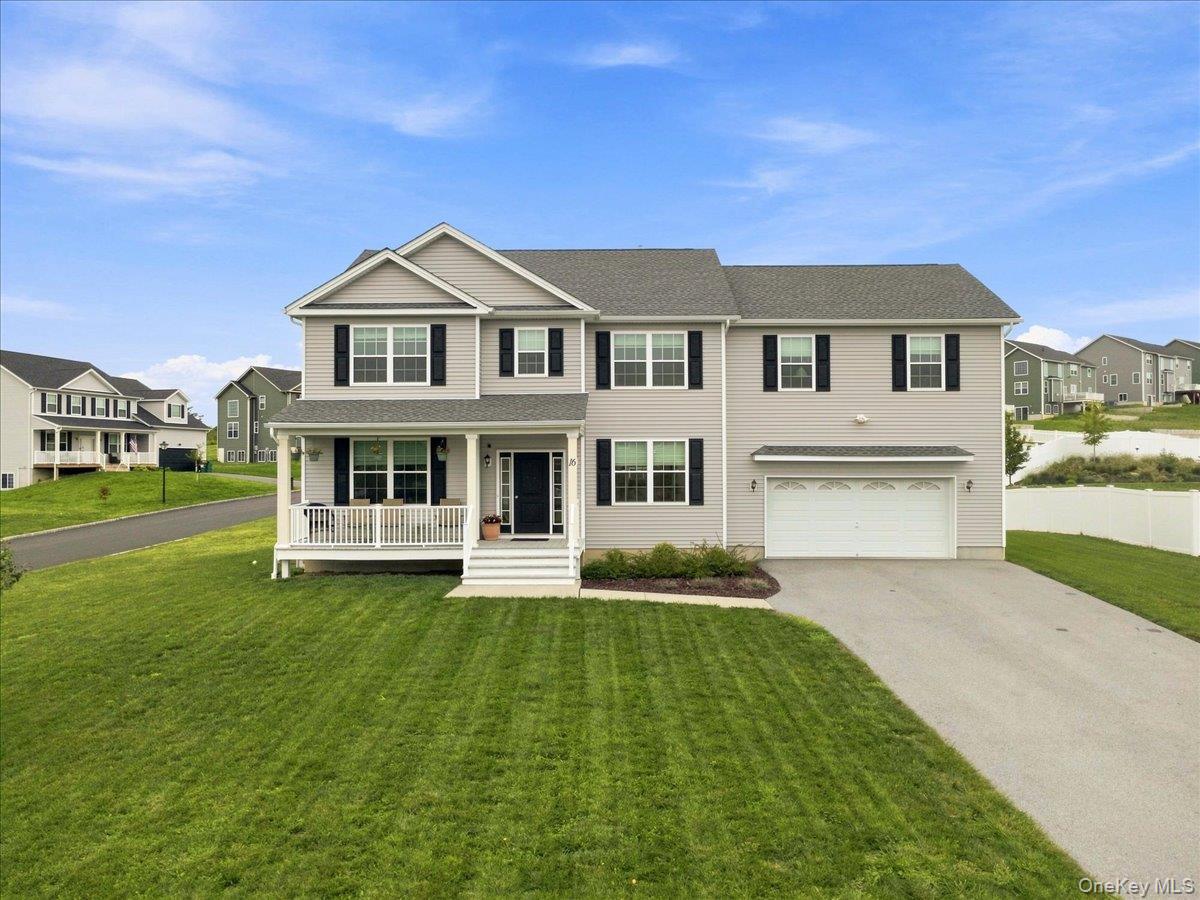 Two-story residence featuring light gray siding with contrasting black shutters, a covered front porch, an attached two-car garage, and a paved driveway