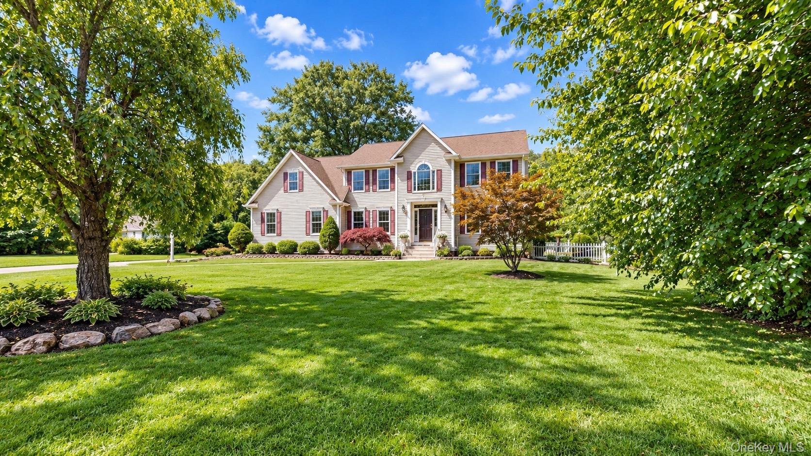 Two-story property with brick and siding exterior, arched window details, and a covered entry