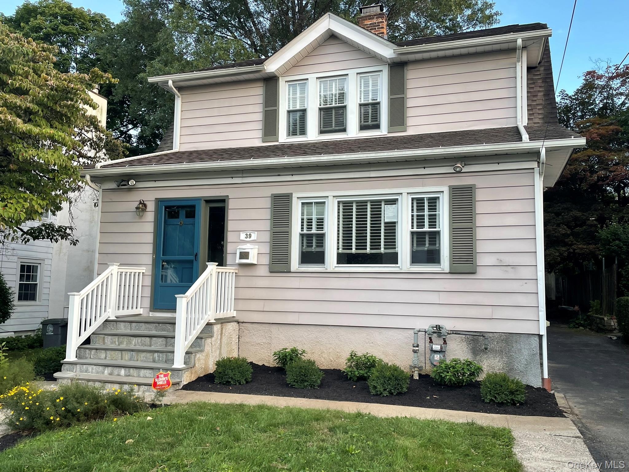 View of front of house with landscaping and a  front yard