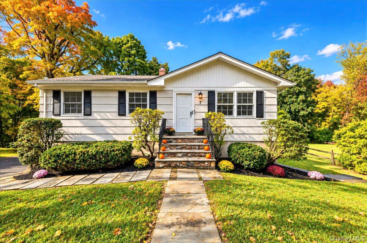 Freshly painted exterior complemented by beautifully maintained landscaping, creating inviting curb appeal.