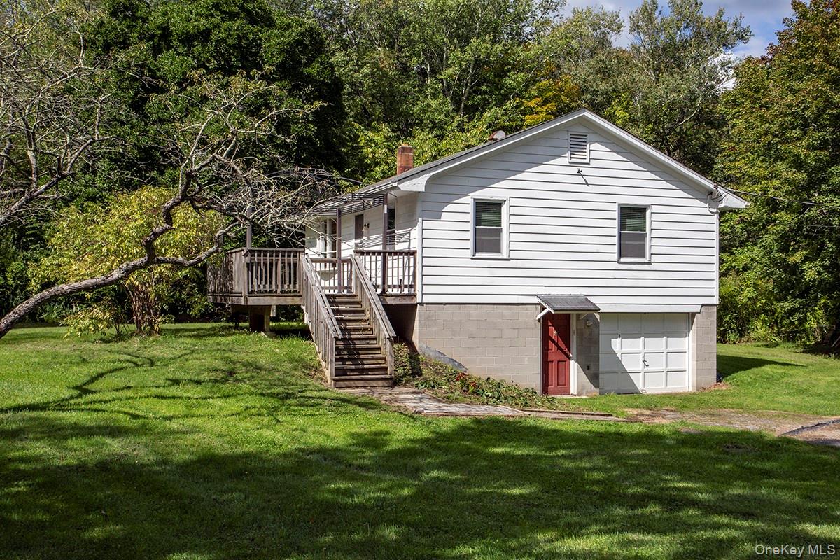 Side of home with Steps to Deck and main enterance.Additional Entry door to garage/basement.