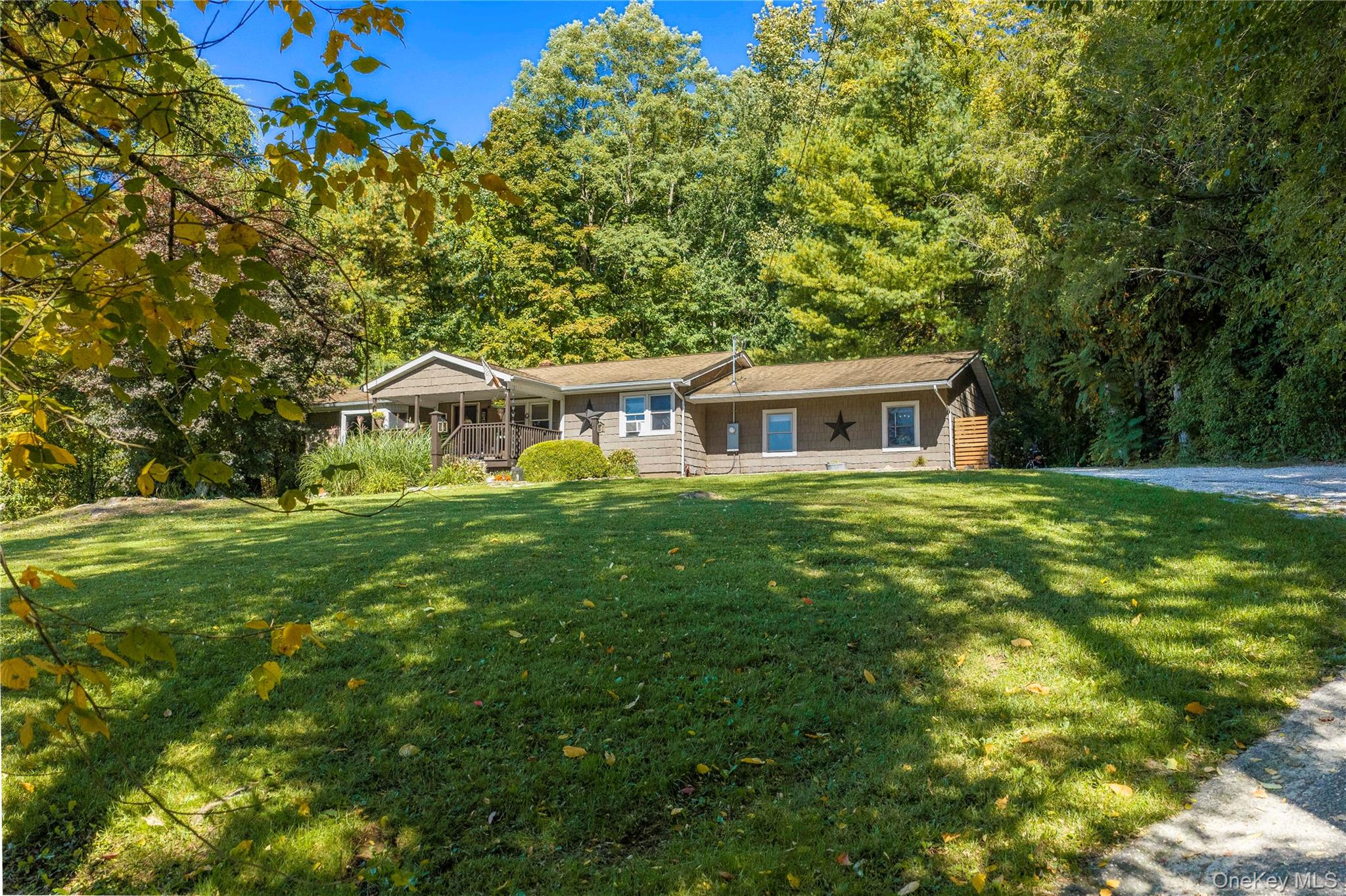 Convenient one-level living meets timeless country charm in this delightful ranch-style home, set high atop almost an acre and perfectly positioned for an easy, comfortable lifestyle.
