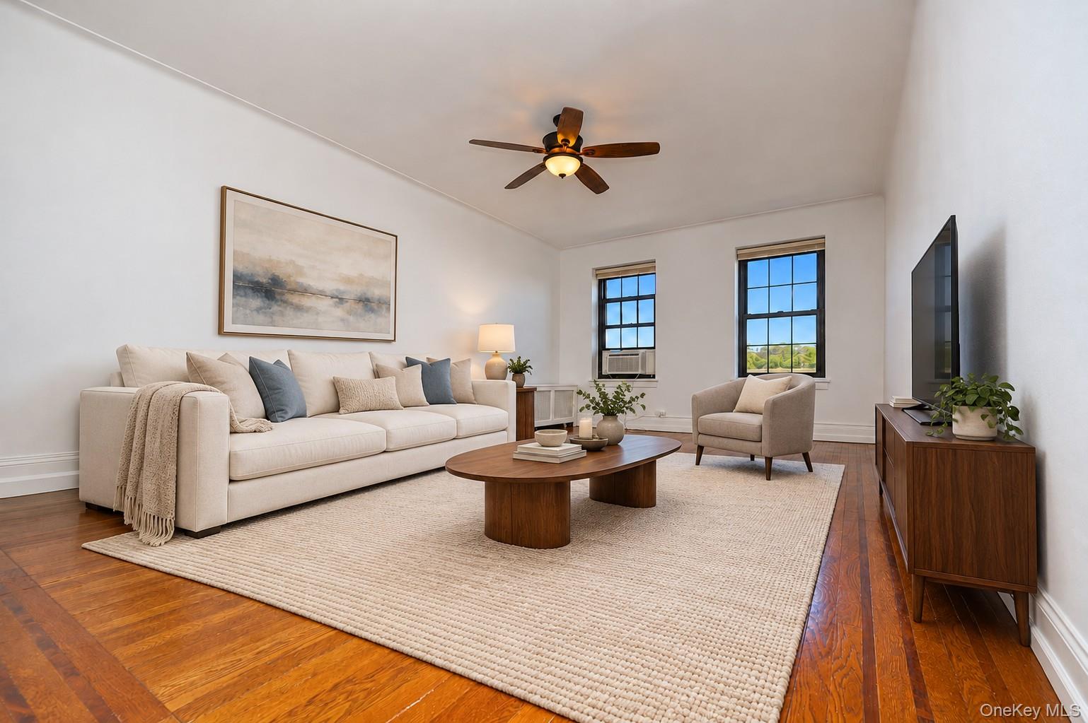 Photo Visually Staged   The large living room has sunny Eastern views, refinished hardwood floors and is approx. 19'-10\" x 13'-4\".