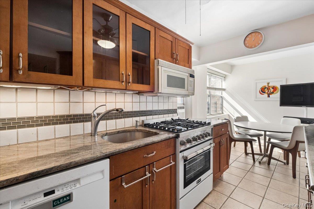 Spacious Eat-in-Kitchen with wood cabinets and granite countertops