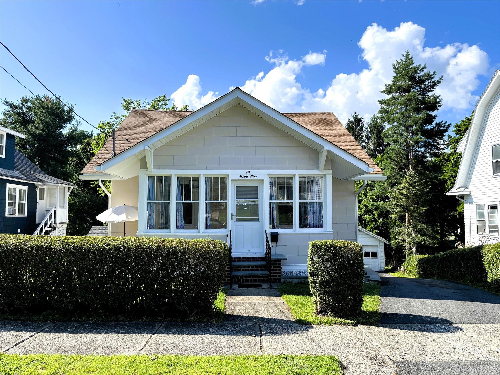 Charming front exterior with a welcoming covered porch.